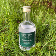 Load image into Gallery viewer, Miniature bottle of The Cobbler Scottish Gin on grass with wild mint and pine needles behind.
